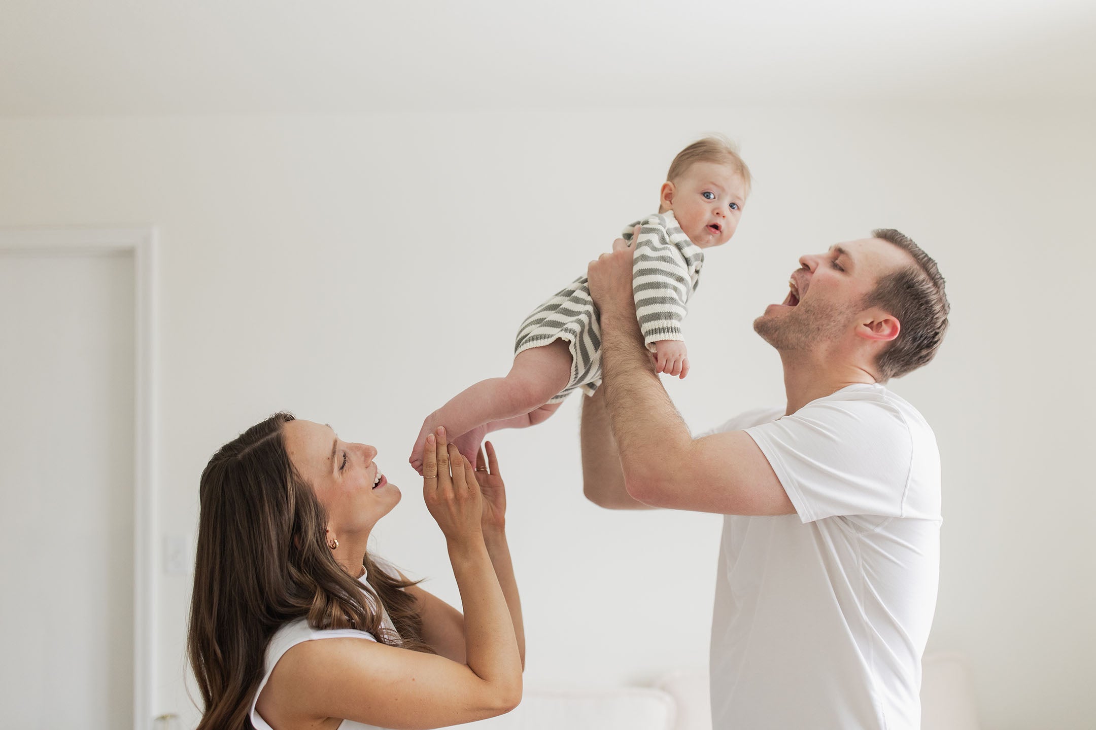 Intimate in-home newborn photography session with new parents and their baby.